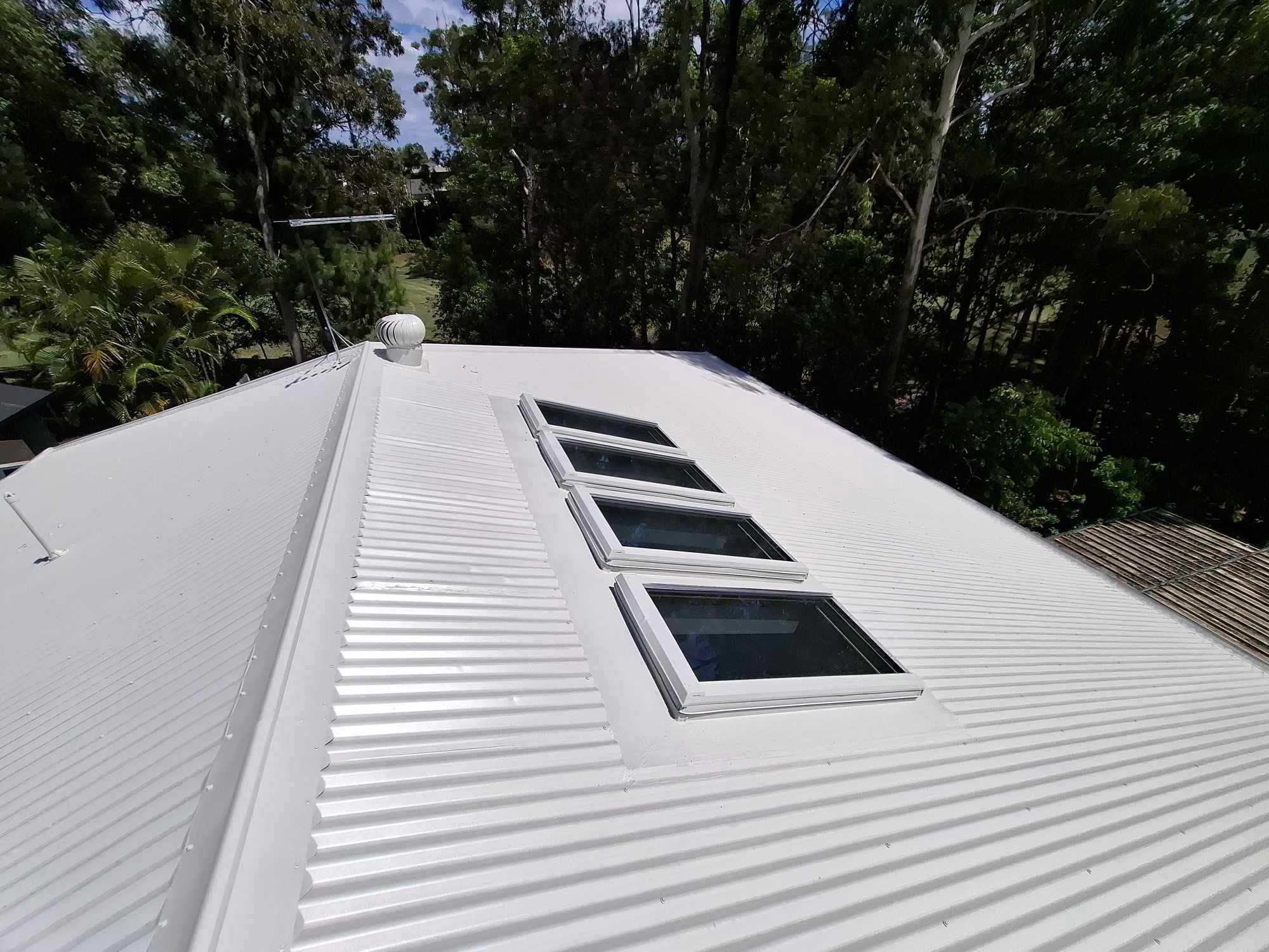 Roof after restoration — fresh colour coat, clean ridge capping